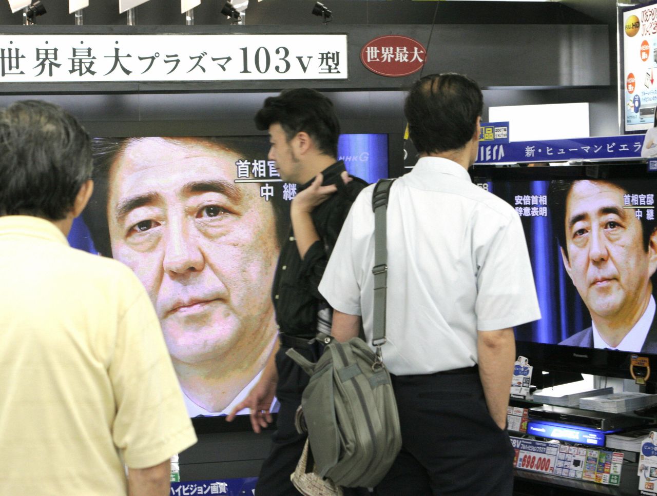 Television screens show Abe as he announces his resignation as prime minister in 2007. He'd been in power for less than a year, but a string of scandals hampered his agenda and sent his approval ratings plummeting.