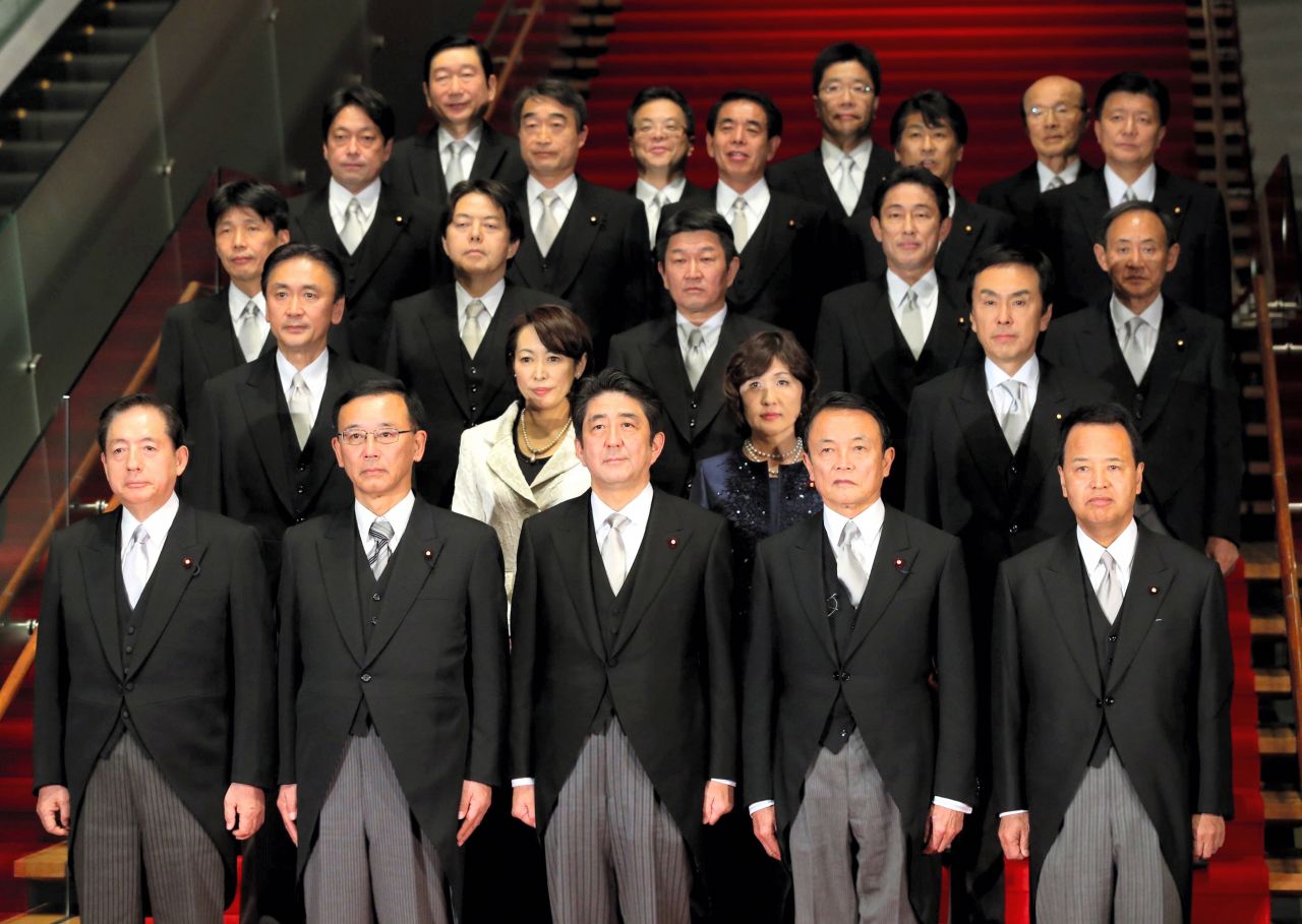 Abe started a second term as prime minister in 2012. Here, he poses for photos with new cabinet members at his official residence in Tokyo.