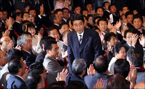 Abe bows to applause from lawmakers of the ruling Liberal Democratic Party after winning the party's presidential election in 2006. He would become Japan's prime minister, succeeding Koizumi.
