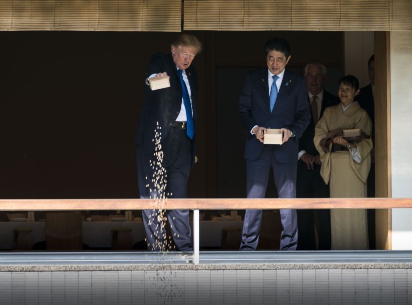 Abe and US President Donald Trump feed koi during Trump's visit to the Akasaka Palace in Tokyo in 2017.