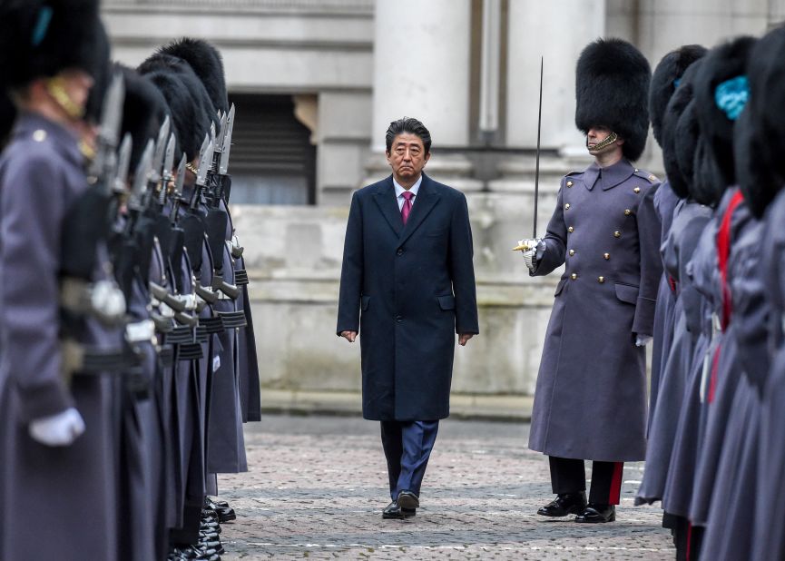 Abe receives a guard of honor while visiting the United Kingdom in 2019.