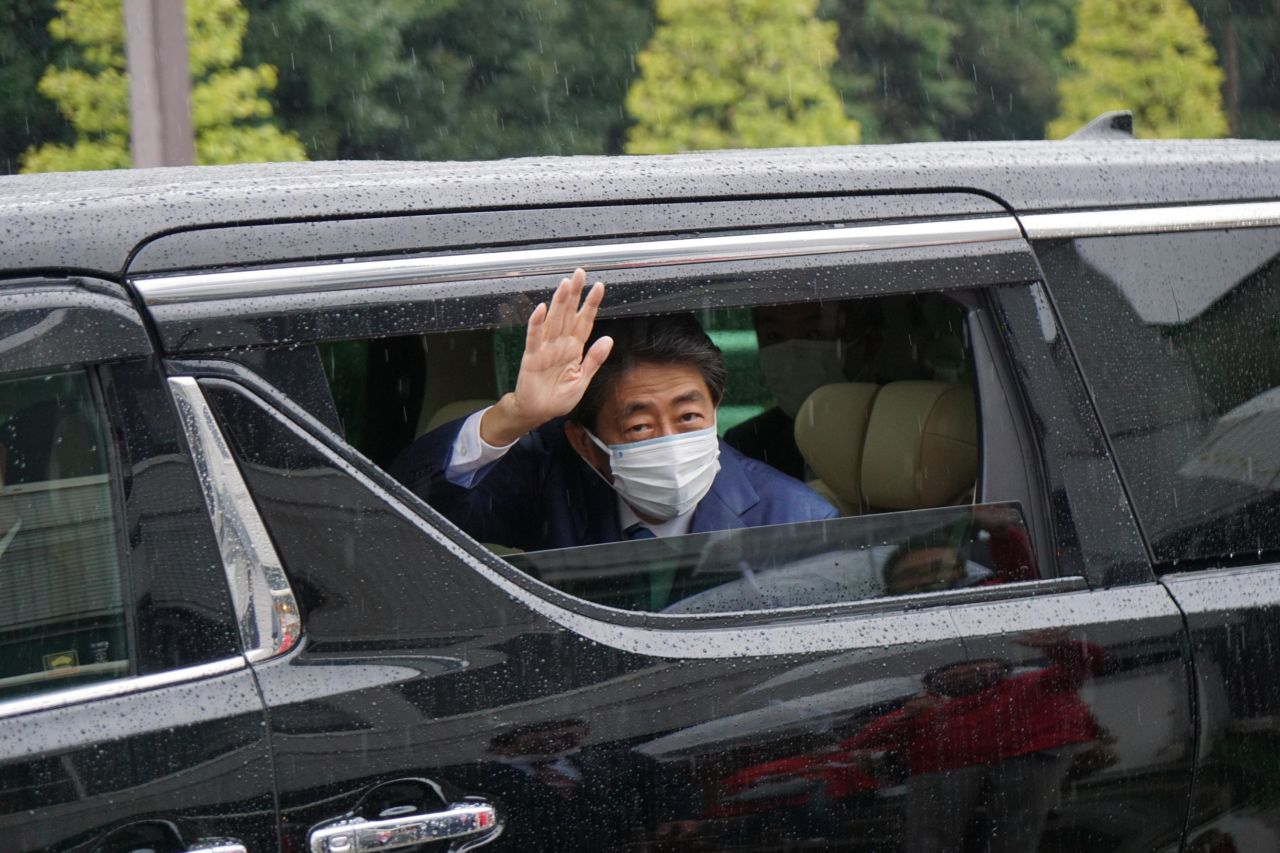 Abe waves from a car window as he leaves a campaign event for the Liberal Democratic Party in Ise, Japan, in 2021. He continued to campaign for his party's candidates until his assassination in July 2022.