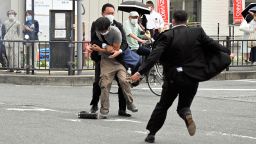 NARA, JAPAN - JULY 08: Security police tackle to arrest a suspect who is believed to shoot former Prime Minister Shinzo Abe in front of Yamatosaidaiji Station on July 8, 2022 in Nara, Japan. Abe is shot while making a street speech for upcoming Upper House election. (Photo by The Asahi Shimbun via Getty Images)