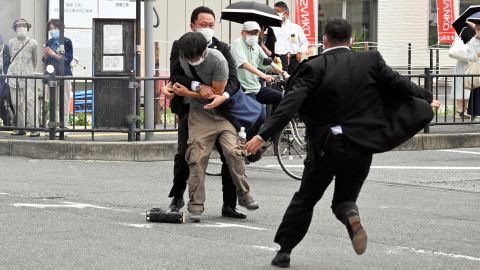Security personnel detain Tetsuya Yamagami near the site where Shinzo Abe was shot in Nara, Japan, on July 8.