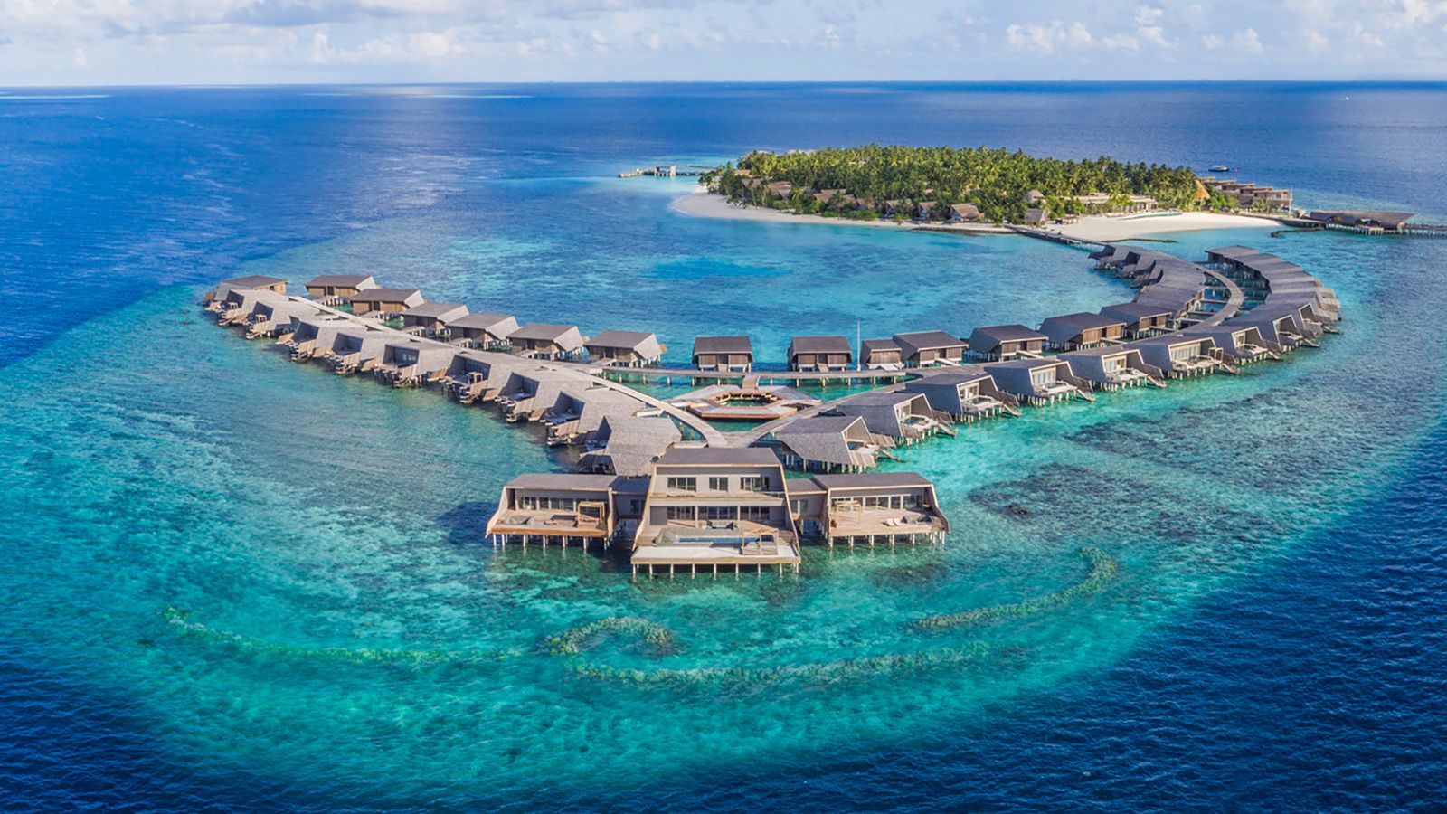 <strong>The St. Regis Maldives Vommuli Resort: </strong>The 44 overwater villas at this resort are modern and minimalist. The bathrooms are covered in slick marble, while the bedrooms are lined with bright, Scandi-style timber.
