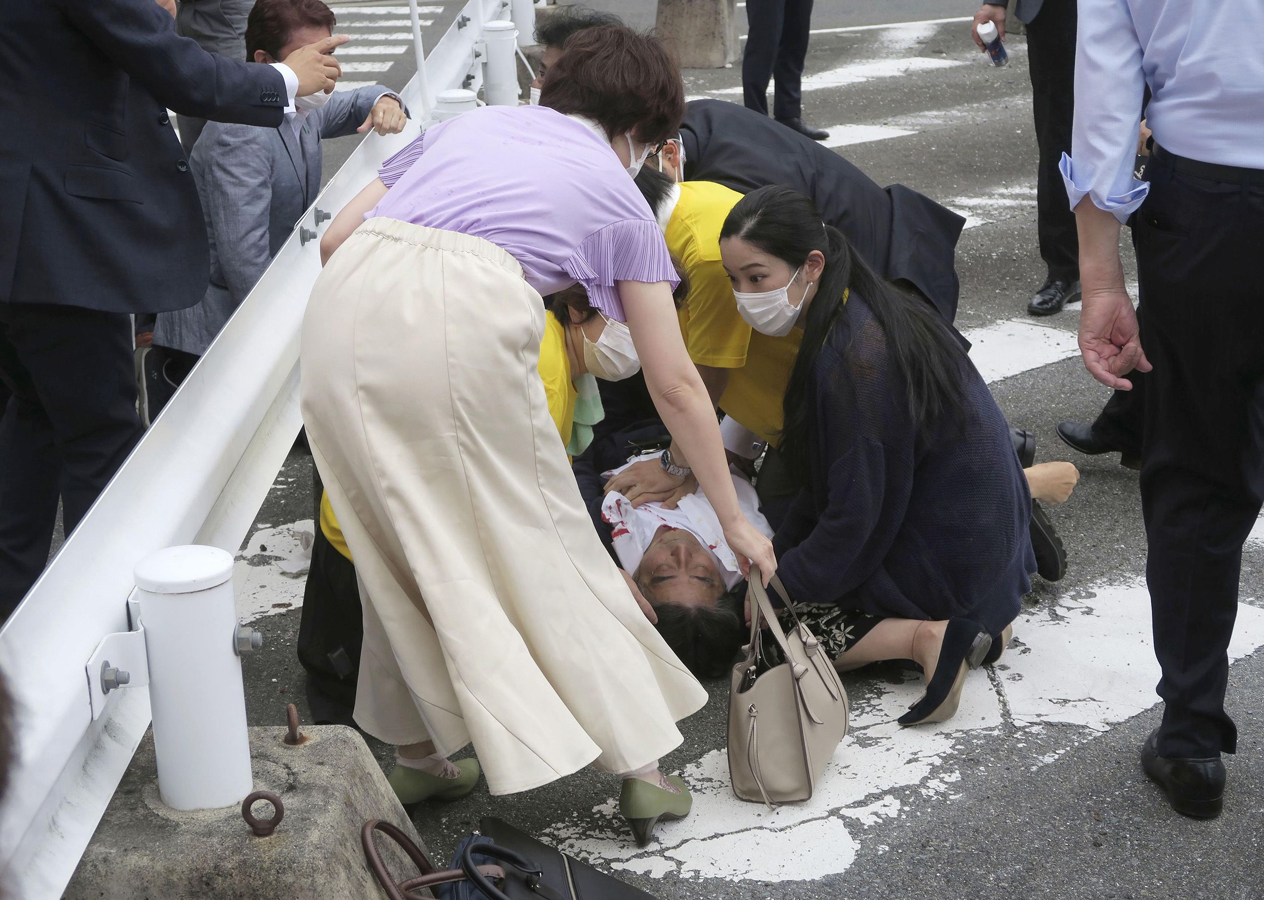 Former Japanese Prime Minister Shinzo Abe is tended to after he was shot while giving a speech in Nara, Japan, on Friday, July 8. Abe, 67, later died.