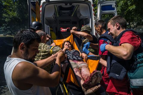 A wounded woman is transported to an ambulance in Kramatorsk, Ukraine, on July 7.