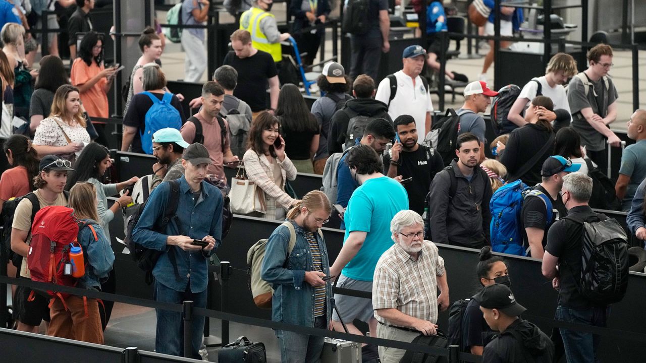 Travelers maneuver through a long line this month at a security checkpoint at Denver International Airport.