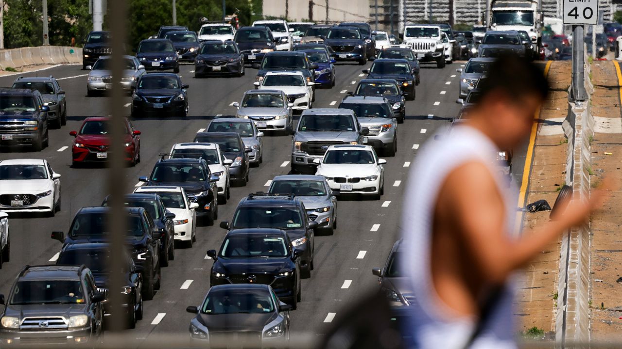 The cost of fuel is a factor on road trips. Here, traffic backs up in June along Interstate 395 in Washington, D.C. 