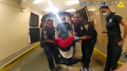 FILE - In this image taken from police body camera video provided by New Haven Police, Richard Cox, center, is placed in a wheelchair after being pulled from the back of a police van after being detained by New Haven Police on June 19, 2022, in New Haven, Conn.  Cox's family met with Justice Department officials, Friday, to discuss possible federal legal action. 
