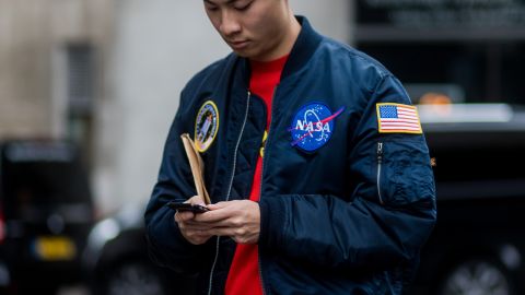A guest wearing a NASA bomber jacket during London Fashion Week Men's collections at Matthew Miller on January 7, 2017 in London, England.
