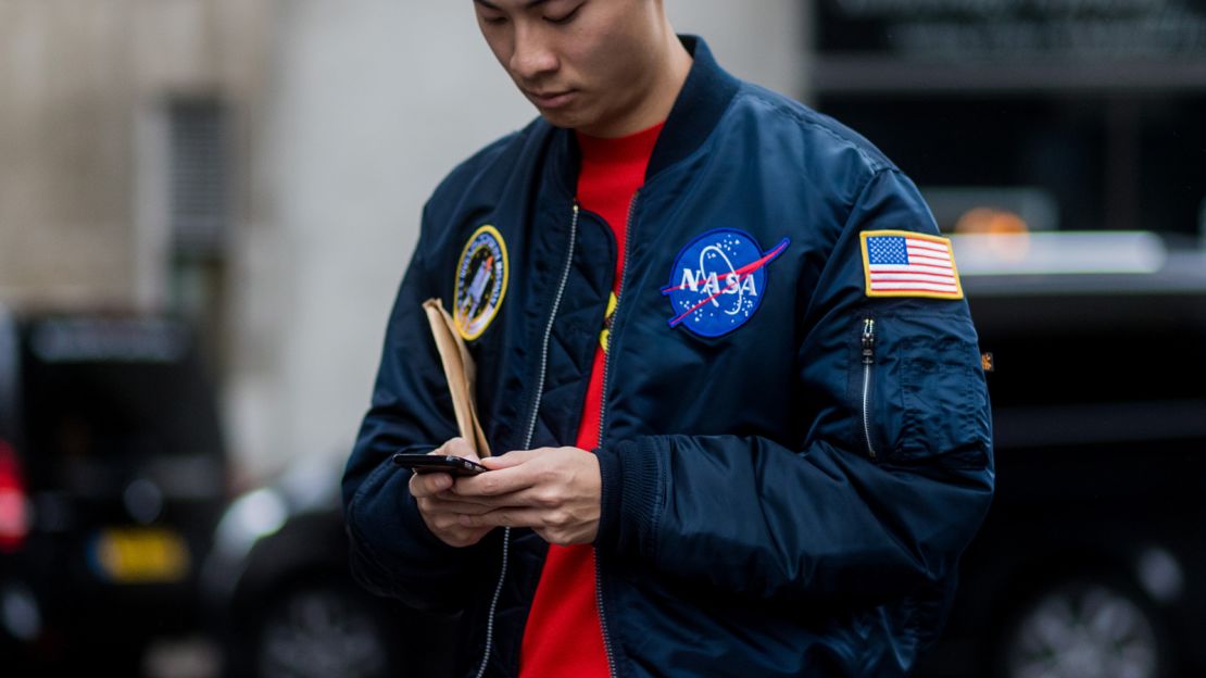 A guest wearing a NASA bomber jacket during London Fashion Week Men's collections at Matthew Miller on January 7, 2017 in London, England.