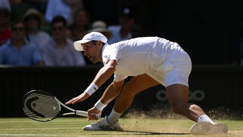 Djokovic slides for a shot against Norrie in their Wimbledon quarter-final. 