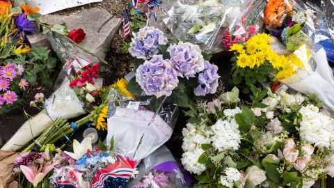 Flowers are laid at a makeshift memorial in Highland Park on July 6.