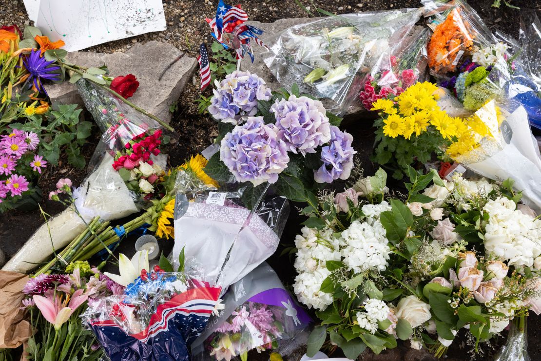 Flowers are laid at a makeshift memorial in Highland Park on July 6.