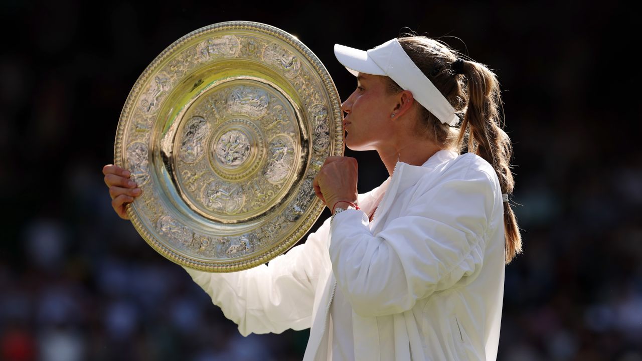 Rybakina kisses the trophy winning the Wimbledon women's singles title.