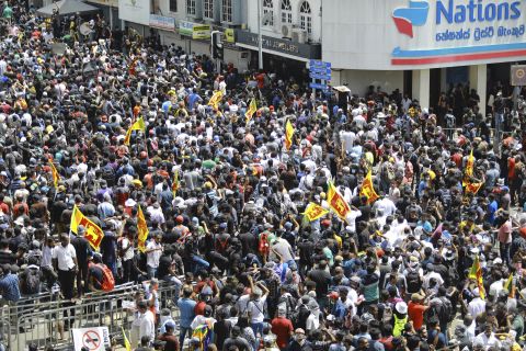 Protesters gather in a street leading to the President's House in Colombo on Saturday.