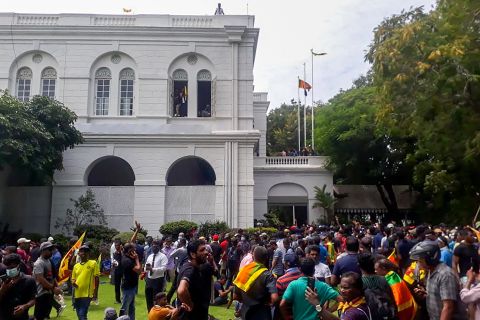 Protesters gather inside the compound of the President's House on Saturday.