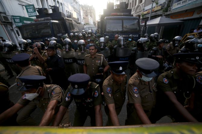 Police stand behind a barricade during a protest near the President's House on Friday.