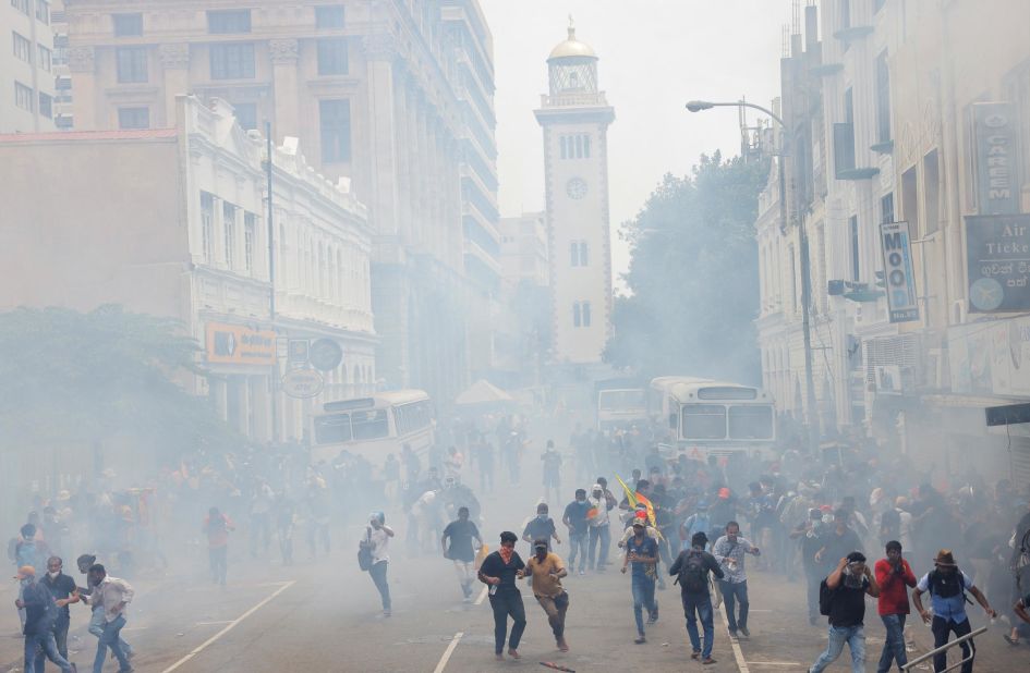 Protesters run from tear gas used by police near the president's residence on Saturday.