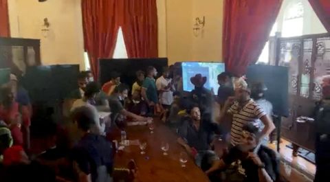 In this image taken from video, people protest inside the President's House on Saturday.
