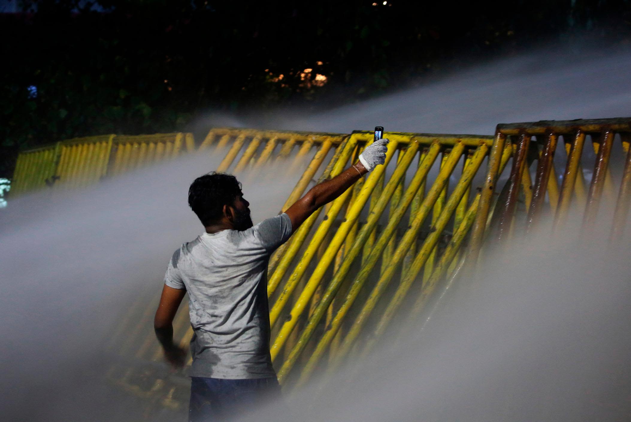 A man holds up his phone during protests in Colombo on Friday.