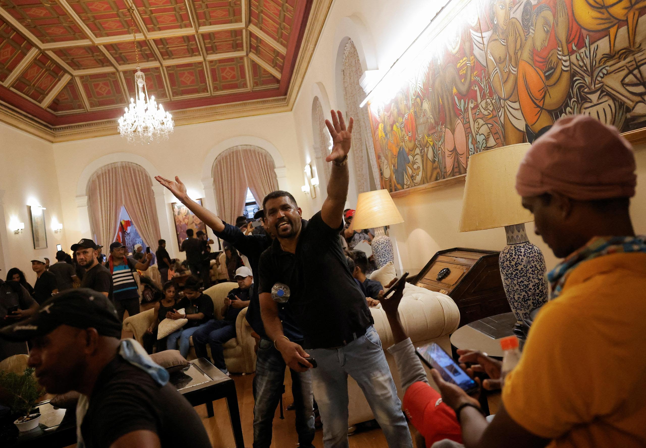 Demonstrators celebrate after entering the President's House on Saturday.