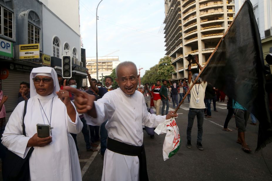 A Catholic priest and a nun shout slogans during a protest near the President's House on Friday.