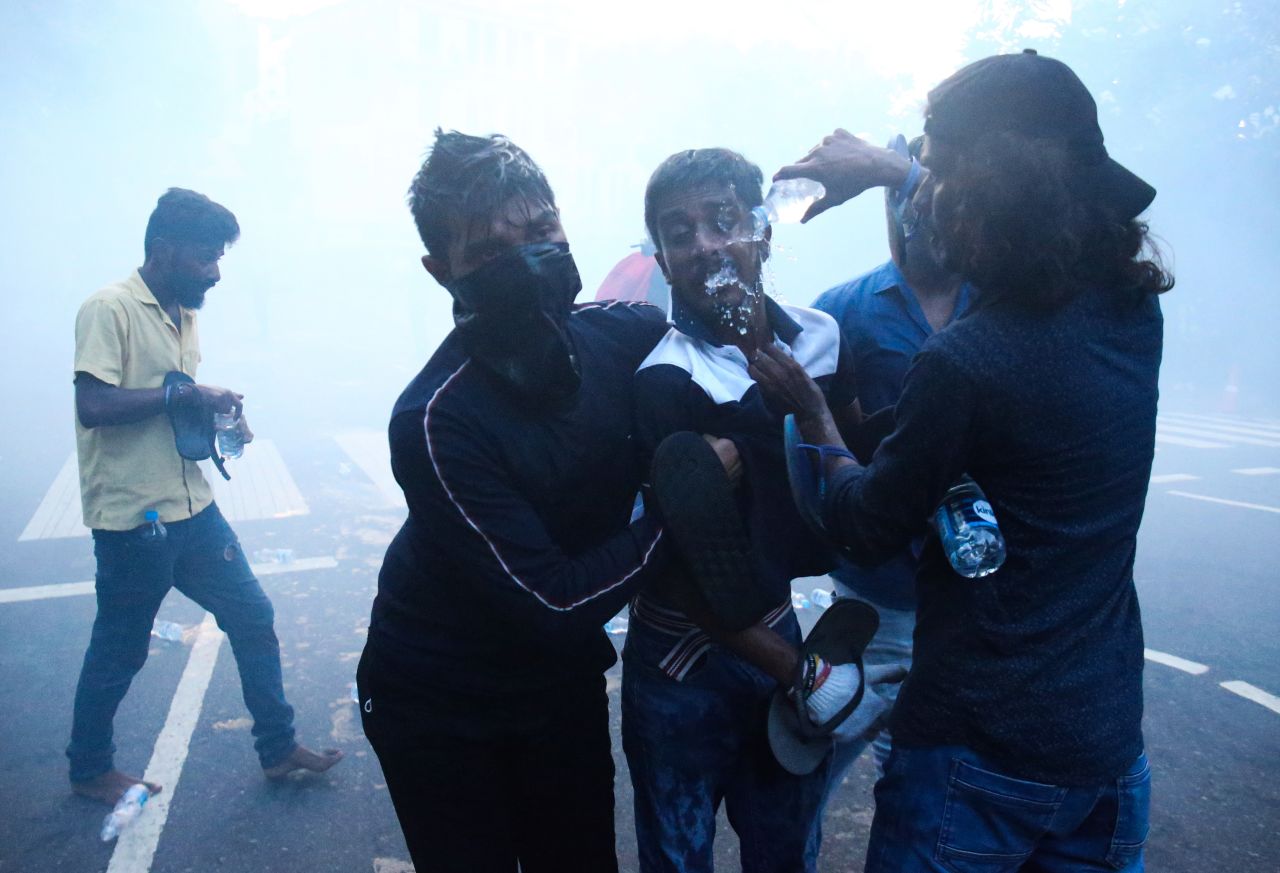 A man has his eyes flushed with water after tear gas was dispersed on protesters in Colombo on Friday.