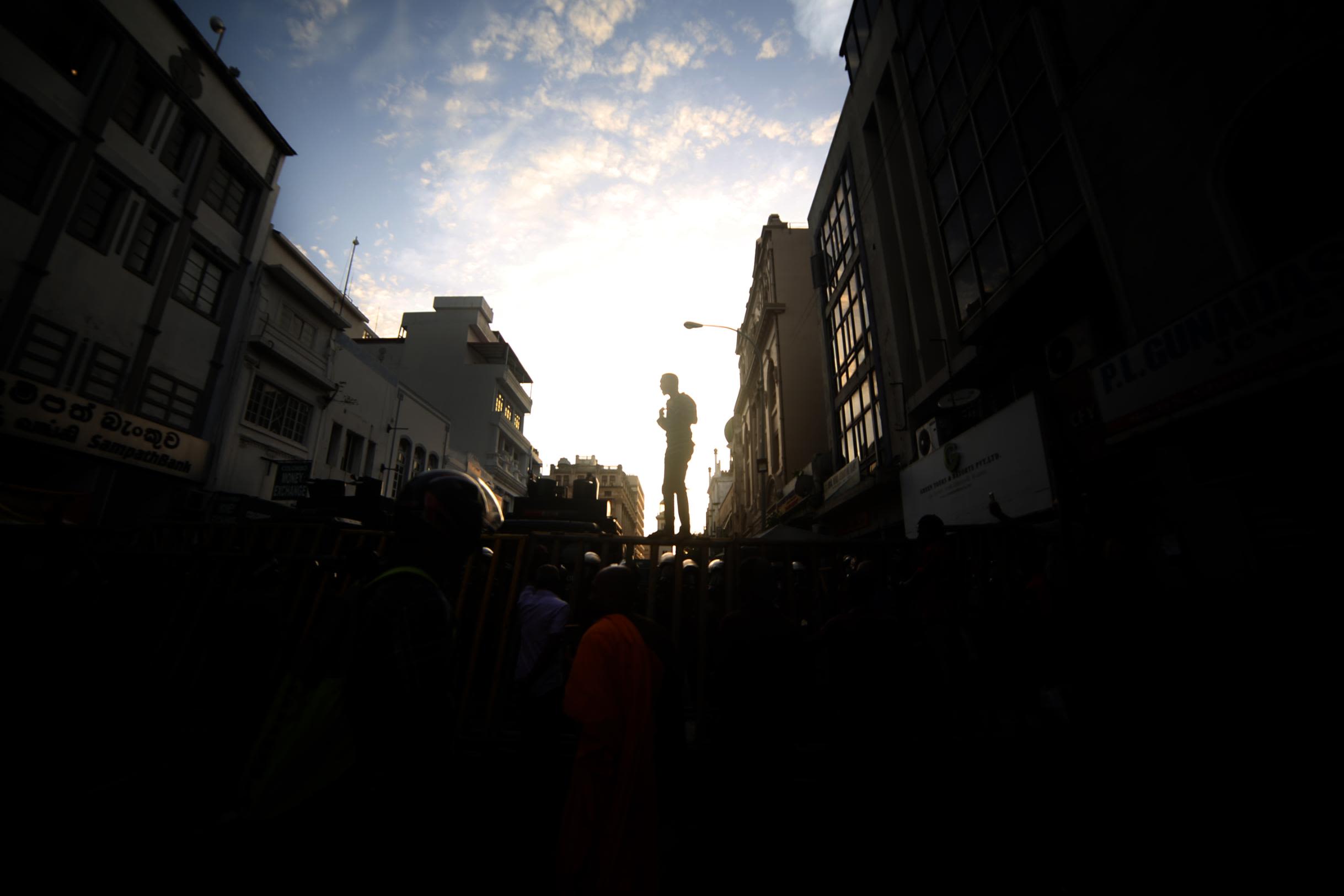 A university student shouts slogans on top of a barricade during a protest Friday.