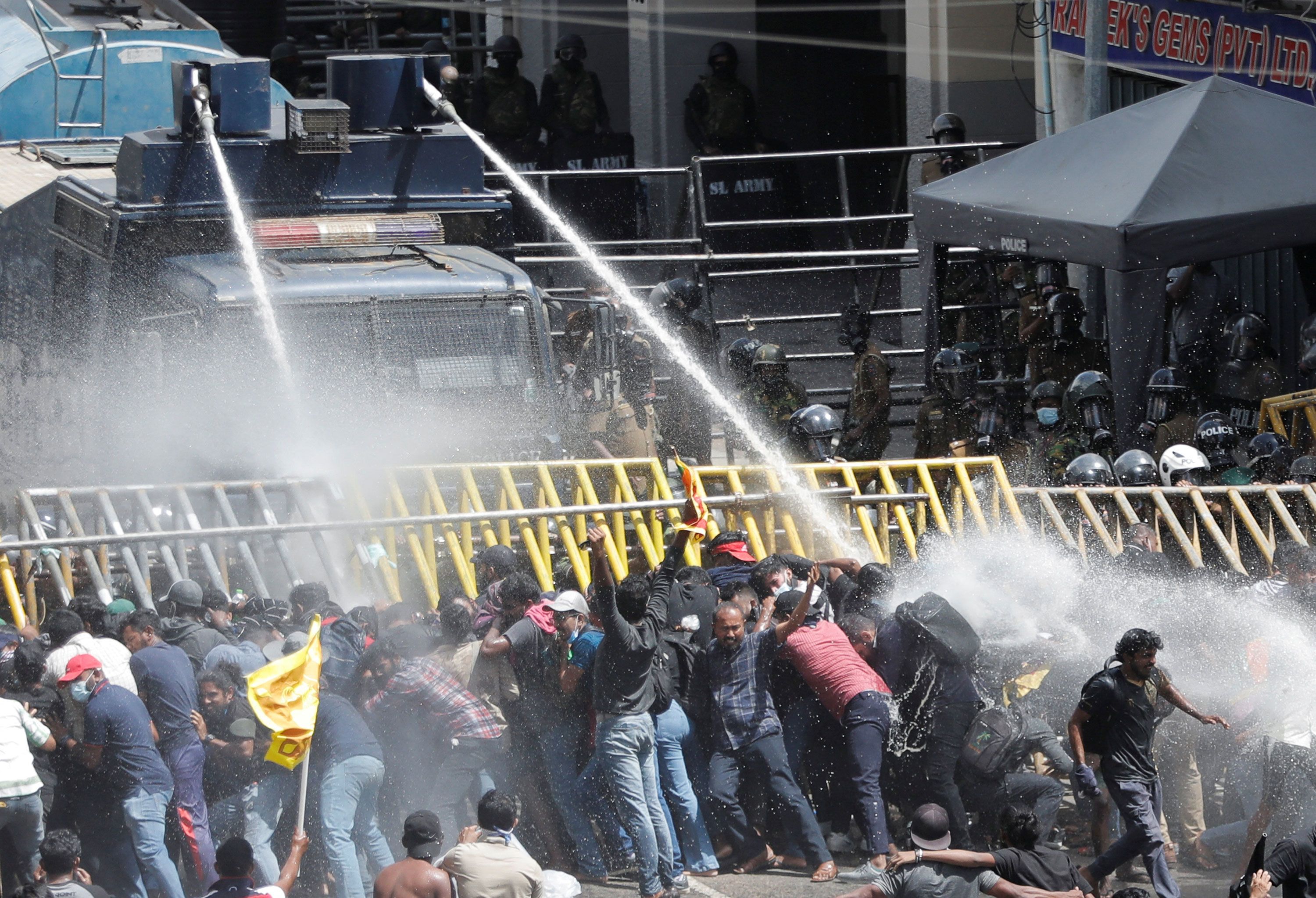 Police use a water cannon as they try to disperse protesters Saturday in Colombo.