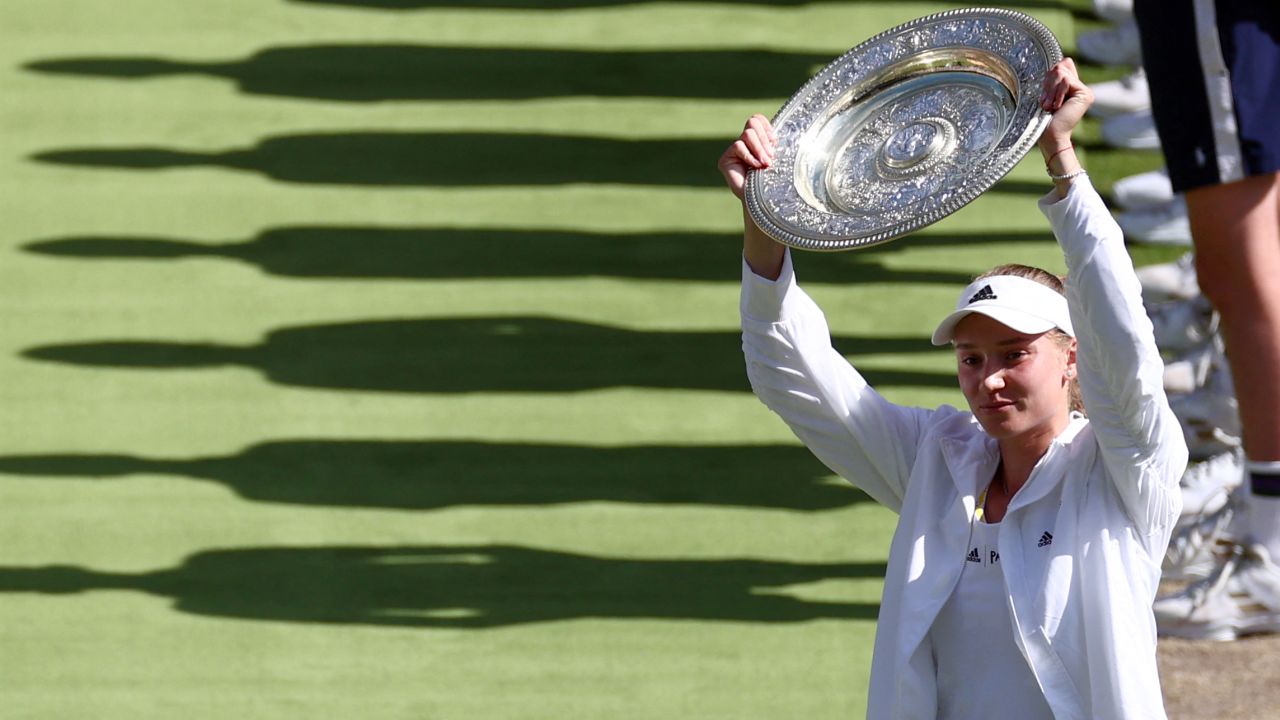 Elena Rybakina celebrates with the Venus Rosewater Dish trophy after winning the women's singles Wimbledon final.