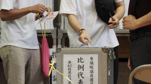 A voter casts a ballot during Japan's upper house elections at a polling station in Tokyo on July 10, 2022.
