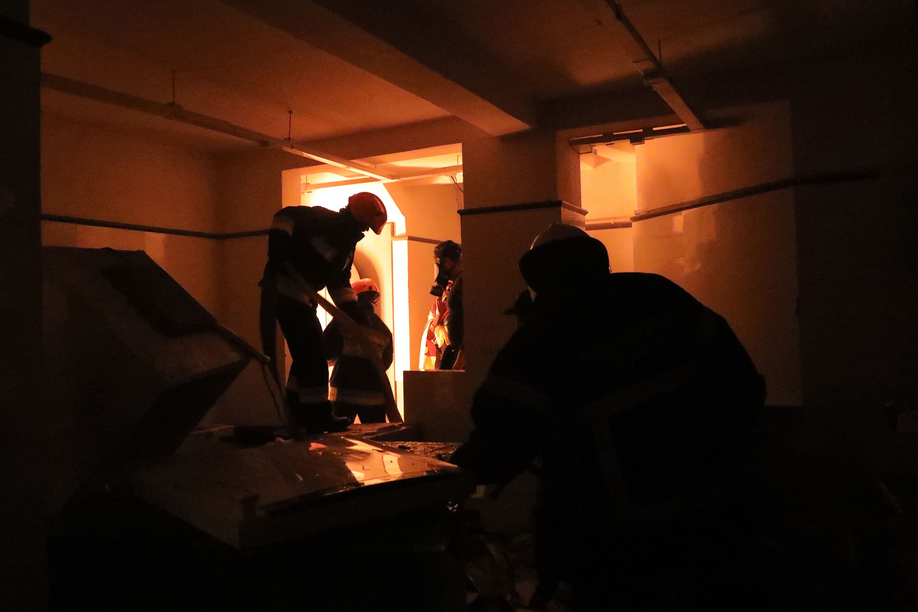 Firefighters work inside the private residence of Prime Minister Ranil Wickremesinghe after protesters set it on fire on Saturday.