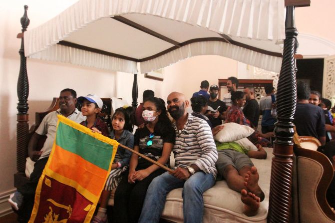 People sit on a bed inside the President's House.