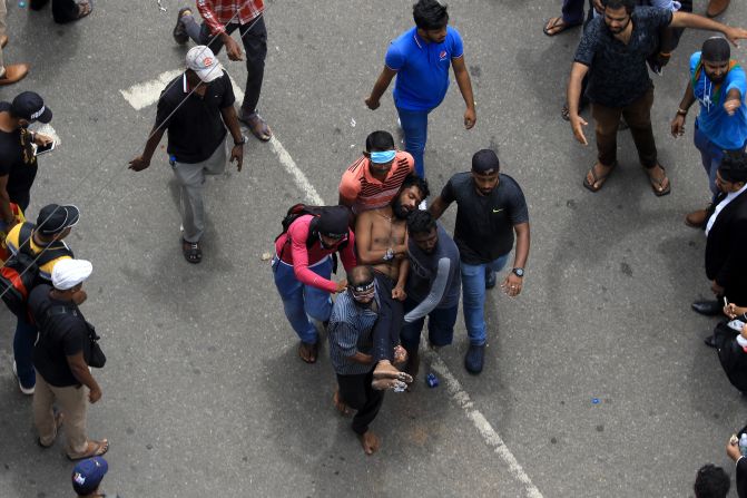 An injured protester is carried away to an ambulance on Saturday.