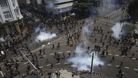 Police fire water and tear gas to disperse protesters gathering in a street leading to the President's official residence on July 9.