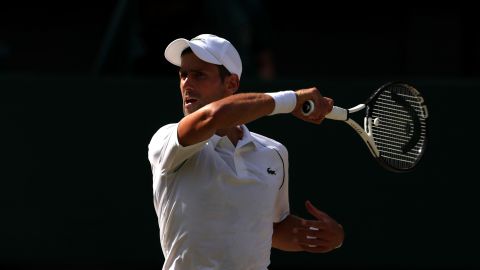 Djokovic plays a forehand against Kyrgios.