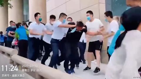 Videos taken by witnesses at the scene show protesters being forcefully taken away by plain-clothes security agents.