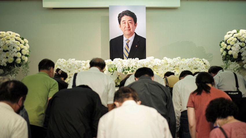 People pay their condolences to former Japanese prime minister Shinzo Abe at the Japan-Taiwan Exchange Association office in Taipei on July 11, 2022. - Abe, Japan's longest serving prime minister, was fatally shot during a campaign stop on July 8 in an exceedingly rare gun crime in one of the world's safest countries. (Photo by Sam Yeh / AFP) (Photo by SAM YEH/AFP via Getty Images)