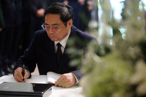 Vietnamese Prime Minister Pham Minh Chinh signs a condolence book for the late former Japanese Prime Minister Shinzo Abe, at the residence of the Ambassador of Japan in Hanoi, Vietnam, on July 11.
