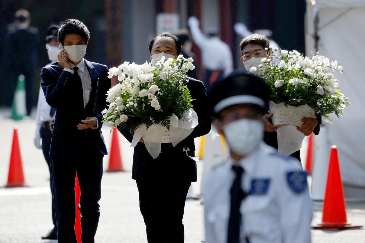Officials carry flowers at the Zojoji Temple, where the vigil and funeral of late former Japanese Prime Minister Shinzo Abe will be held, in Tokyo, Japan, on July 11.