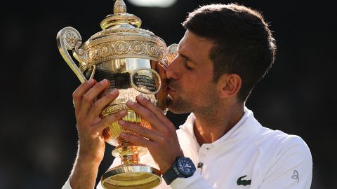 Djokovic kisses the trophy after defeating Kyrgios in the men's singles final at Wimbledon.