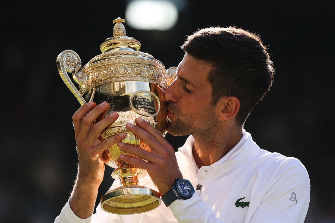 Djokovic kisses the trophy after defeating Kyrgios in the men's singles final at Wimbledon.