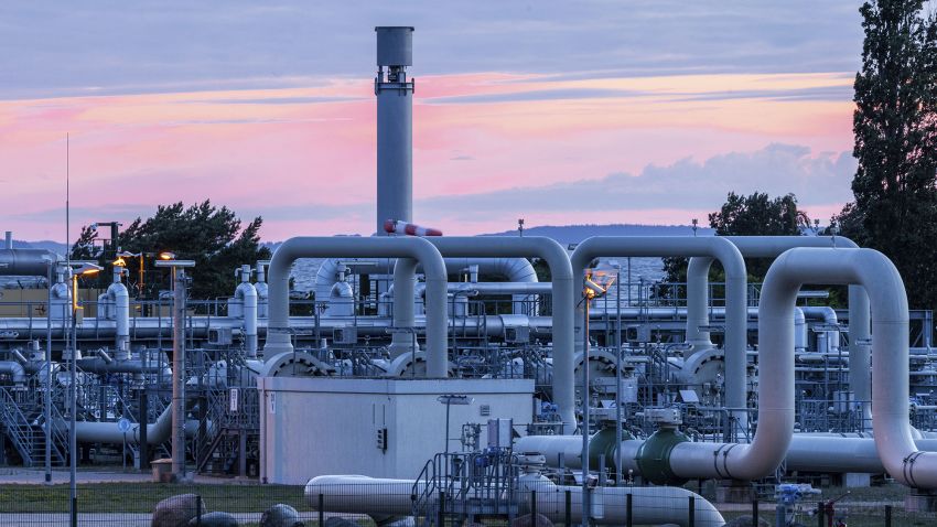 The sun rises behind the pipe systems and shut-off devices at the gas receiving station of the Nord Stream 1 Baltic Sea pipeline and the transfer station of the OPAL gas pipeline, Baltic Sea Pipeline Link, in Lubmin, Germany, Monday, July 11, 2022. The Nord Stream 1 pipeline, Germany's main source of Russian gas, is scheduled to be out of action until July 21, 2022, for routine work. The operator said the gas flow was reduced progressively starting at 6 a.m. 