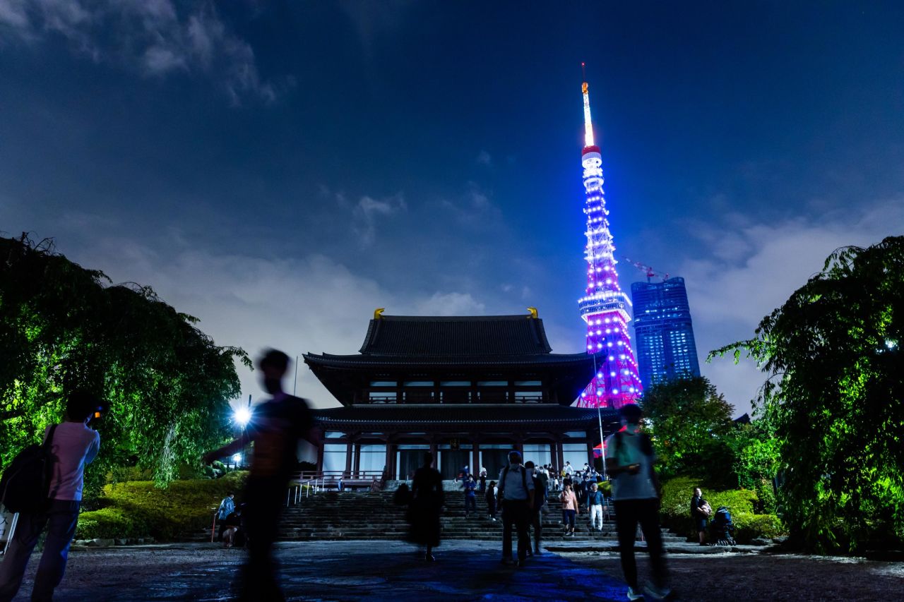 People gather at Tokyo's Zojoji Temple a night before the funeral of former Japanese Prime Minister Shinzo Abe.