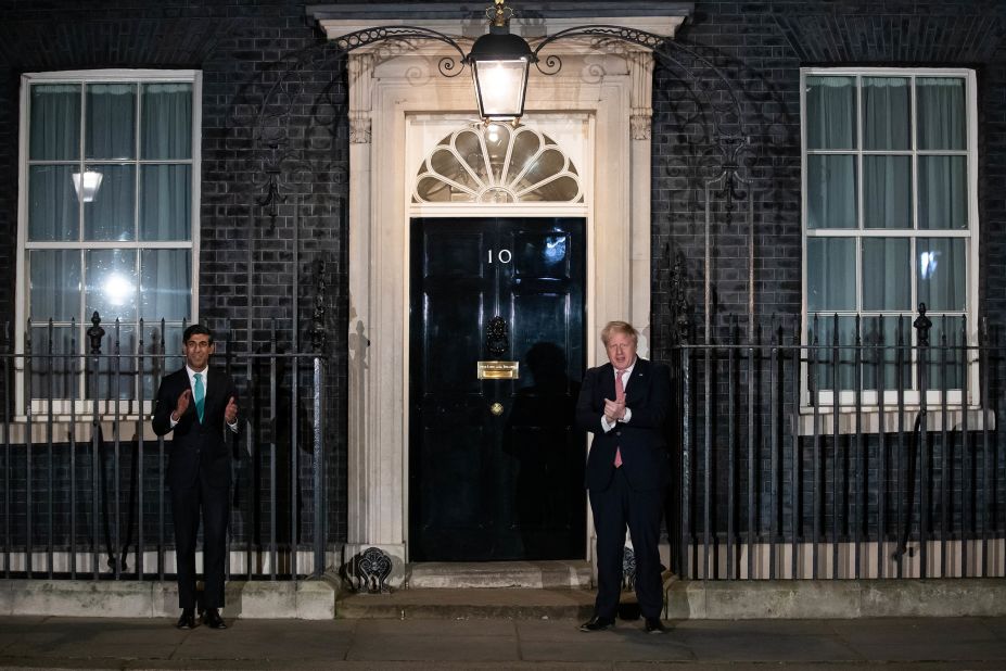 Johnson and Chancellor Rishi Sunak, outside of No. 10 Downing Street, join a national applause showing appreciation for health-care workers during the Covid-19 pandemic.