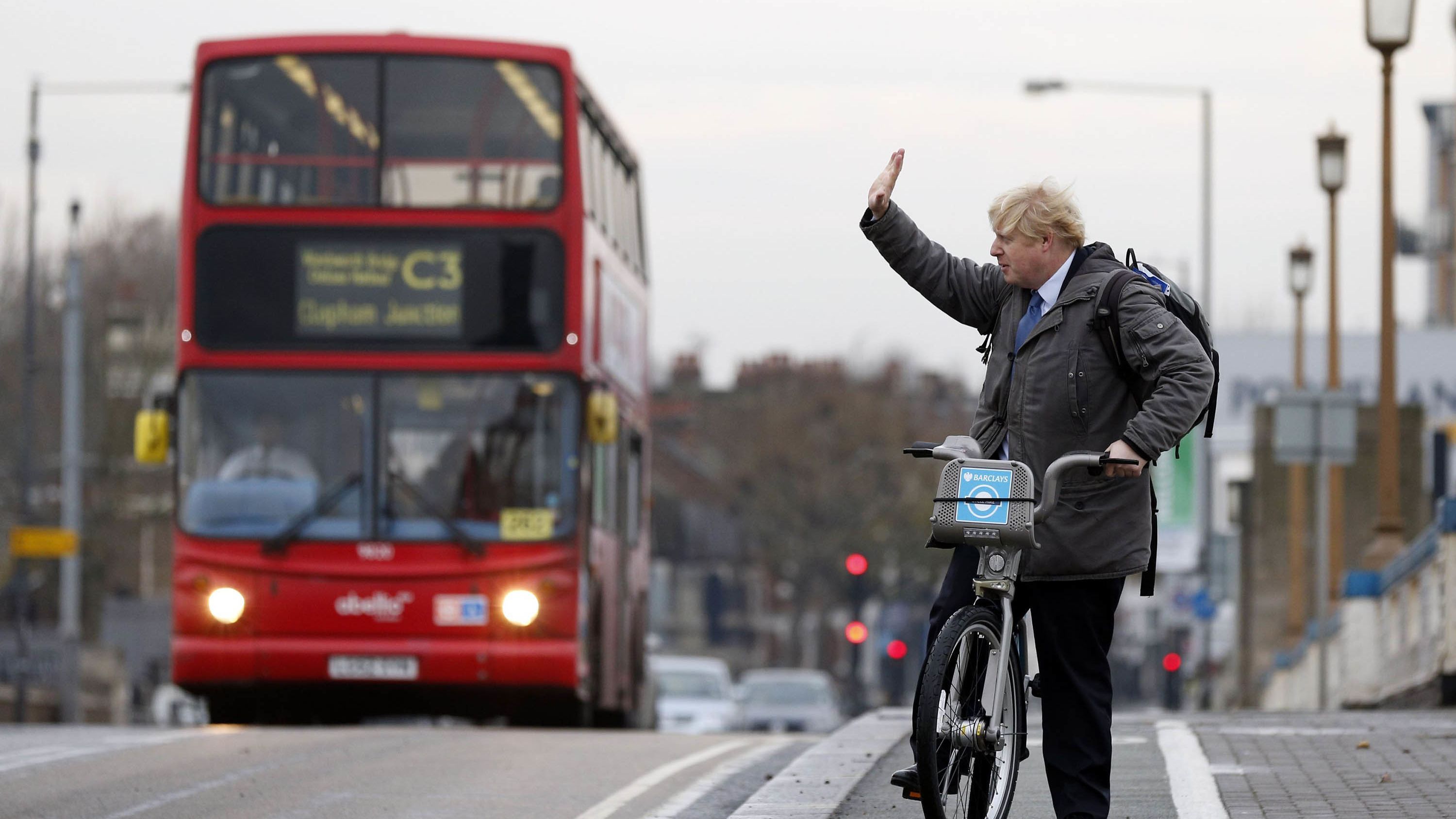 Johnson waves on London's Wandsworth Bridge as a bike-sharing program was expanded in the city in 2013.