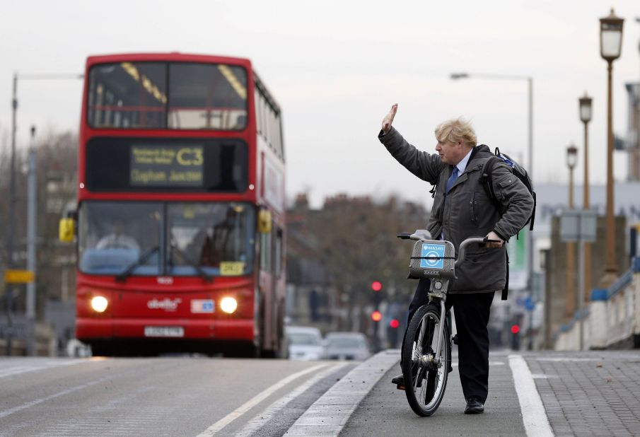 Johnson waves on London's Wandsworth Bridge as a bike-sharing program was expanded in the city in 2013.