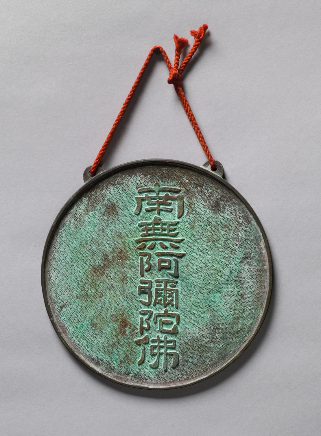 A second bronze plate, which is marked with the name of the Amitabha Buddha, is thought to have been soldered onto the back, concealing the image of the Buddha.